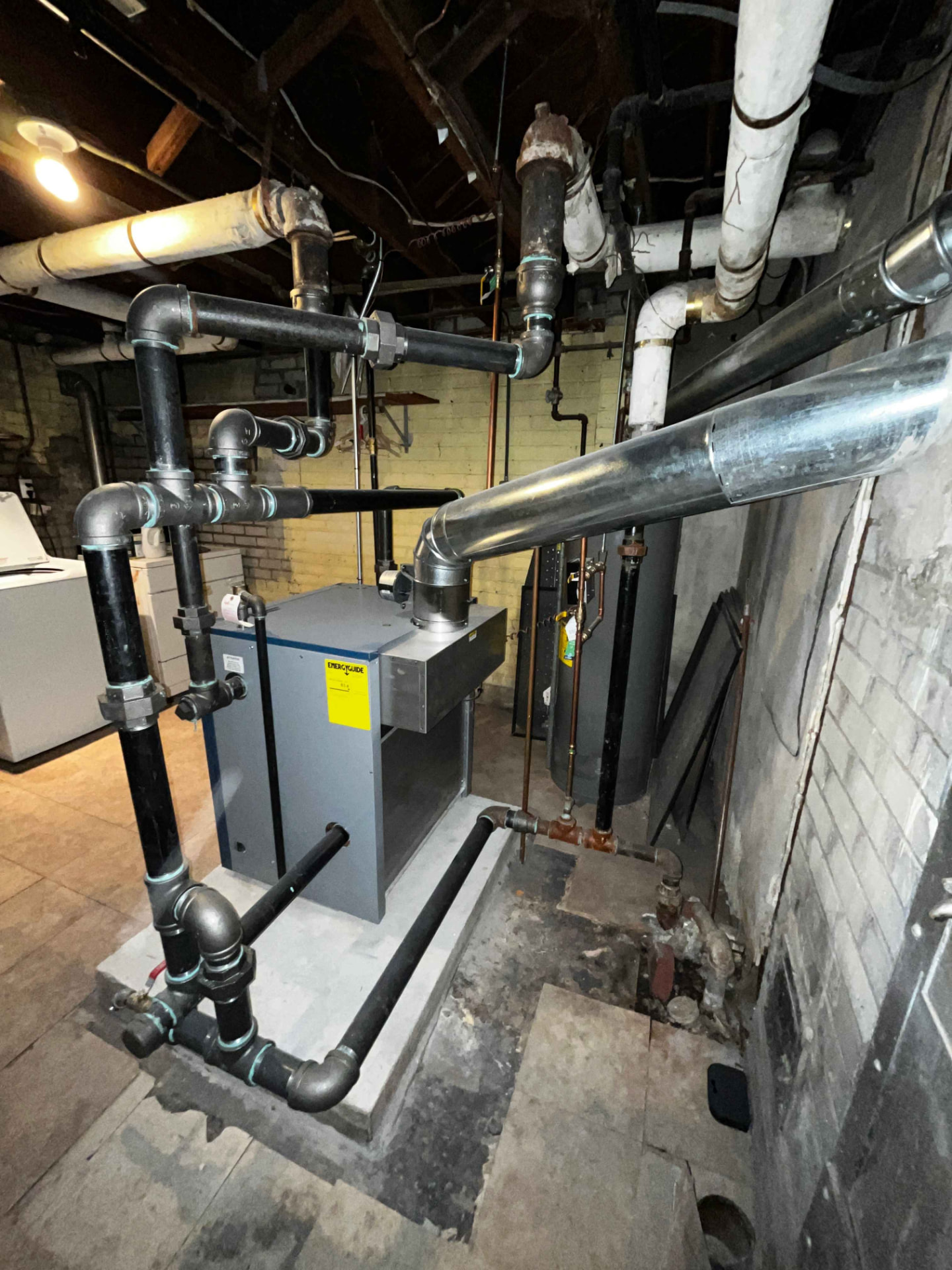 Boiler replacement with repiped manifold — New boiler, new gas piping and a level pad